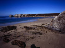 France, Bretagne, Crozon Peninsula, Pointe de Penhir from above veryach beach with rocky foreshore in foreground.