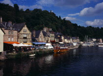 France, Bretagne, Cotes d'Armor, medieval market town of Dinan with houses and restaurants overlooking boat moorings on the river rance.