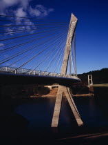 France, Bretagne, Finistere, low viewpoint from south bank right hand side looking up at the pont de terenez suspension bridge over the river aulne completed in 2011.