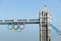 England, London, The Olympic rings suspended from the gantry of London's Tower Bridge celebrate the  2012 games. Tower bridge is a combined bascule and suspension bridge and was completed in 1894.