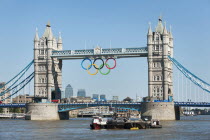 England, London, The Olympic rings suspended from the gantry of London's Tower Bridge celebrate the 2012 games. Tower bridge is a combined bascule and suspension bridge and was completed in 1894.