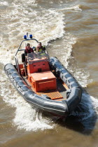 England, London, City Airport fire and rescue boat on the river Thames near Tower bridge.