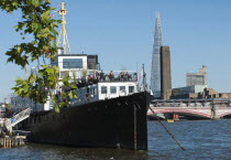 England, London, The Shard and Tate Britain with HMS President moored in the Thames near the Embankment station for more than 80 years. Built in 1918 she saw service as a convoy protection vessel in w...