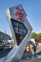 England, London, Trafalgar Square, A young girl poses for a photograph in front of the Olympic Countdown clock.