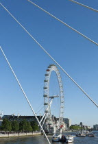 England, London, London Eye at the Millennium Pier seen through the supports of Hungerford bridge.