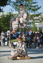 England, London, Jubilee Gardens, Levitation trick being performed by street artist.