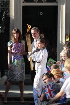 England, London, Olympic Torch relay in Downing Street, Samantha and Prime Minister David Cameron welcome the torch.