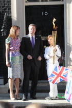 England, London, Olympic Torch relay in Downing Street, Samantha and Prime Minister David Cameron welcome the torch.