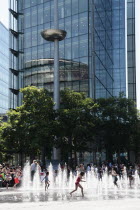 England, London, Southwark, Children playing in fountains next to City Hall.