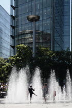 England, London, Southwark, Children playing in fountains next to City Hall.