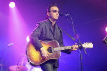 England, Cambridge Folk Festival, Richard Hawley performing on stage with acoustic guitar.