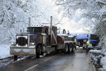 Weather, Winter, Snow, Recovery truck extracting a Jack-knifed fuel tanker on icy A22 main road near Nutley, East Sussex after heavy snowfall.