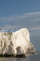 England, East Sussex, Seaford Head, snow on cliffs with people toboganing.