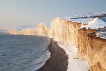England, East Sussex, Seven Sisters, Snow covered chalk cliffs looking west towards Cuckmere haven from Birling Gap.