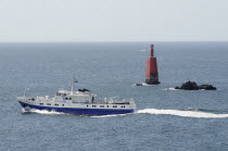 France, Brittany, Penn Ar Bed passenger ferry passing close to the pointe de Penhir on its way from Camaret-sur-Mer to the Isle de Sein.