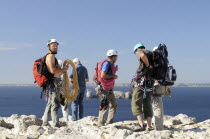 France, Brittany, Gulf of Brest, Climbers preparing to scale Pointe de Penhir.