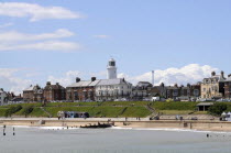 England, Suffolk, Southwold, historic seafront with lighthouse from the pier.