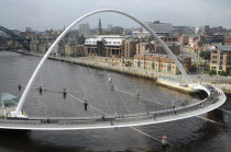 England, Tyneside, Newcastle, Gateshead Millennium Bridge in closed position from the Baltic Arts Centre looking towards Newcastle Quayside and Newcastle upon Tyne city.