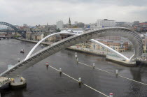 England, Tyneside, Newcastle, Gateshead Millennium Bridge in open position from the Baltic Arts Centre looking towards Newcastle Quayside and Newcastle upon Tyne city.