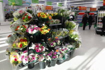 Food, Shopping, Supermarket, bunches of fresh flowers for sale by entrance.