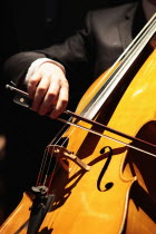Music, Instruments, Strings, Cello, detail of hand using bow across the strings.