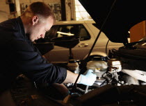 Transport, Road, Repair, mechanic working on car in garage.