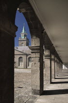 Ireland, County Dublin, Dublin City, Kilmainham, Royal Hospital,  the courtyard cloister viewed through arch.