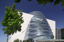 Ireland, County Dublin, Dublin City, the Convention Centre building, view of the facade with tree in foreground.
