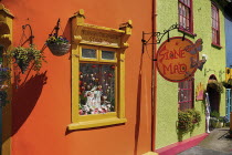 Ireland, County Cork, Kinsale, colourful facades in market place with flower pots.