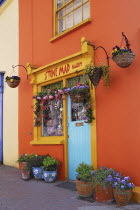 Ireland, County Cork, Kinsale, colourful facade in market place with flower pots.