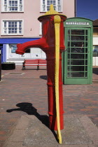 Ireland, county Cork, Kinsale, colourful old water pump and telephone box .