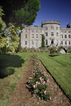 Ireland, County Sligo, Markree Castle hotel, view of a section of the castle with row of flowers in the foreground.