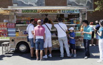 Italy, Lazio, Rome, Tourists at a fast food van near the Colosseum