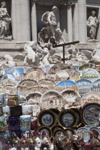 Italy, Lazio, Rome, Display of tourist souvenir gifts beside the baroque Trevi Fountain by Nicola Salvi 1762 against the Palazzo Poli.