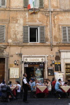 Italy, Lazio, Rome, Diners eating al fresco at a restaurant in a back street.