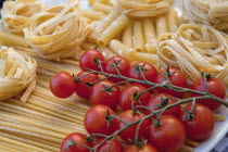 Food, Italian, Dried pasta and tomatoes on the vine.