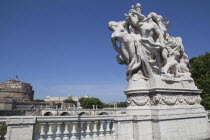 Italy, Lazio, Rome, Statue on the Ponte Vittorio Emanuele II with Castel Sant Angelo in the background.