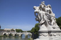 Italy, Lazio, Rome, Statue on the Ponte Vittorio Emanuele with Castel Sant Angelo in the background.