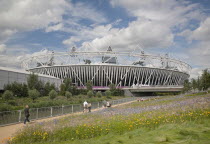 England, London, Stratford, View of the 2012 Olympic Stadium with meadow planting in the foreground.