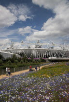 England, London, Stratford, View of the 2012 Olympic Stadium with meadow planting in the foreground.