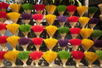 Vietnam, Thuy Zuan Hat village, Colourful bundles of incense sticks for sale.