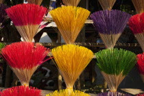 Vietnam, Thuy Zuan Hat village, Colourful bundles of incense sticks for sale.