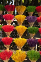 Vietnam, Thuy Zuan Hat village, Colourful bundles of incense sticks for sale.