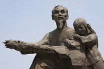 Vietnam, Ho Chi Minh City, Statue of Ho Chi Minh holding a child outside the Peoples Committee Building.