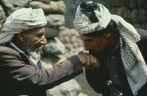 Sudan, Ben Amer-beja nomad men greeting eachother by kissing the hand.