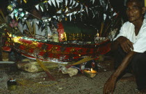 Cambodia, Shaman or Acar with ritual model boat.