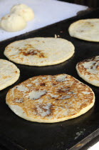 Mexico, Bajio, San Miguel de Allende, Cooking tortillas on griddle.