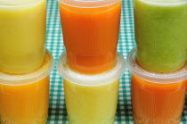 Mexico, Bajio, Guanajuato, Yellow, green and orange jugos or fruit juices.