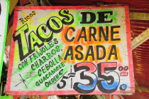 Mexico, Bajio, Zacatecas, Sign for taco food stall with highlighted text and price.