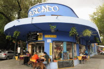 Mexico, Federal District, Mexico City, Condesa District, Street restaurant, blue painted exterior with customers sitting at outside tables.